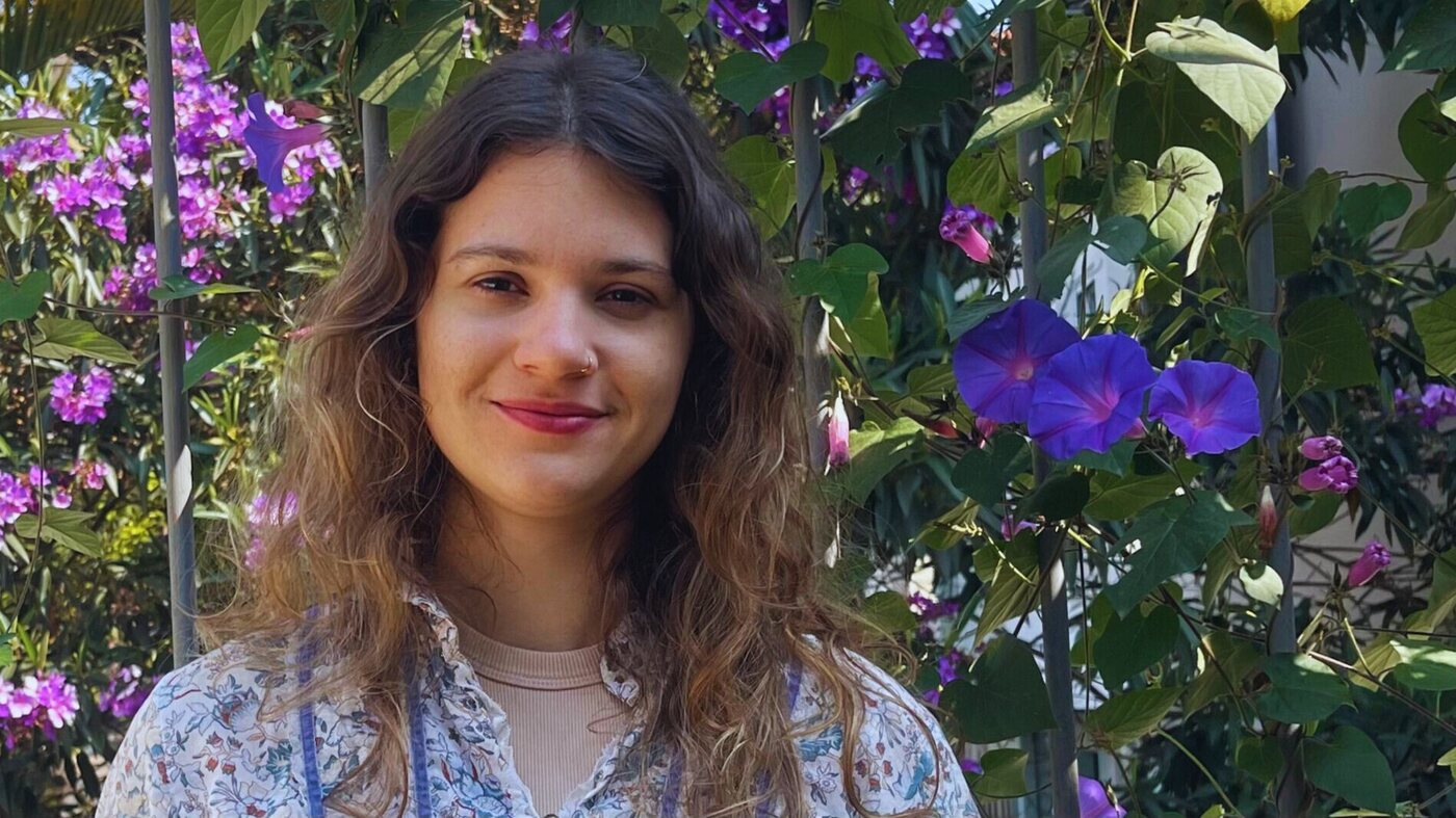 Retrato de Raffaella Perracini diante de flores